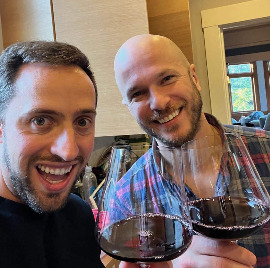 Tyler and Zach raising their wine glasses
